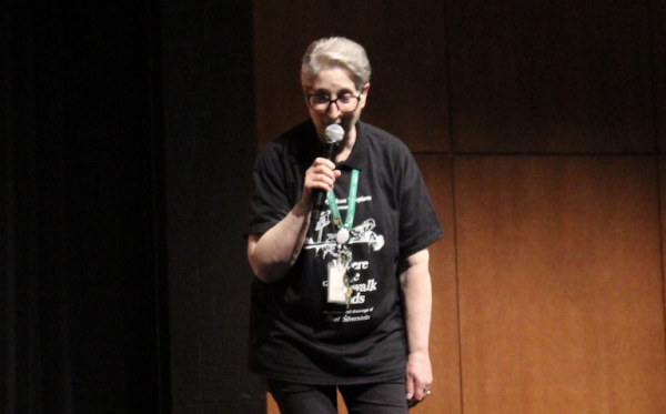 Theater teacher Danielle Trebus speaks to the audience at the matinee presentation of "Where the Sidewalk Ends" April 24.